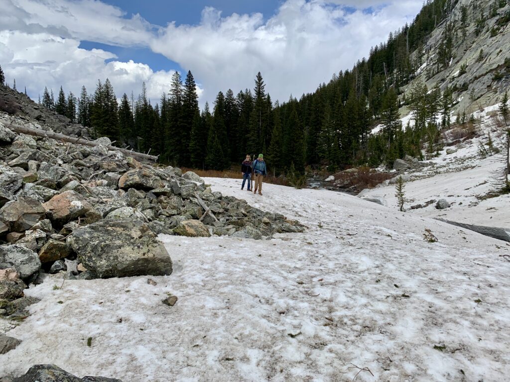 A hike to Hidden Falls, Inspiration Point and into Cascade Canyon in Grand Teton National Park. Crossing a snow covered area of a rock slide in Cascade Canyon, Grand Teton National Park, Wyoming.