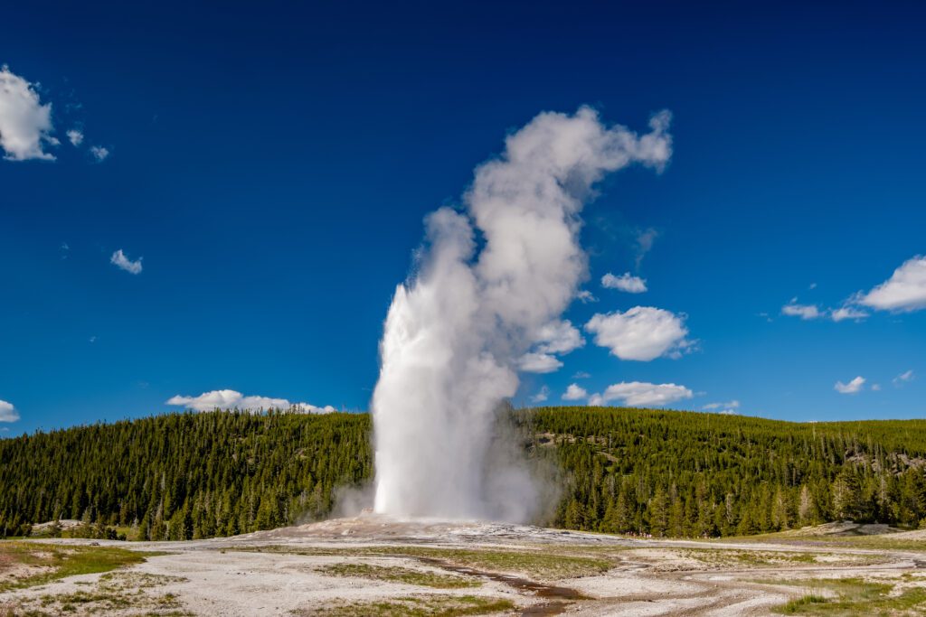 Popular Scenic Drives in Yellowstone National Park and Tourist Sites. Old Faithful geyser in Yellowstone National Park.